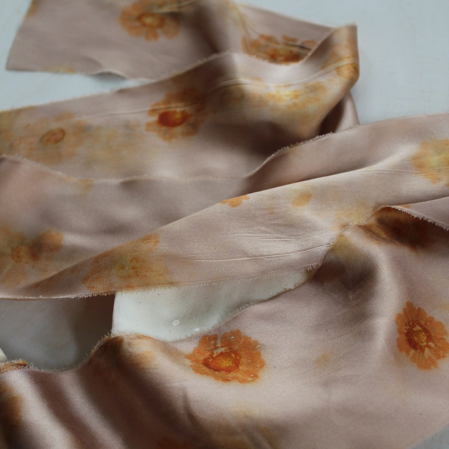 close up Delicate silk charmeuse ribbon with one-of-a-kind natural dye pattern