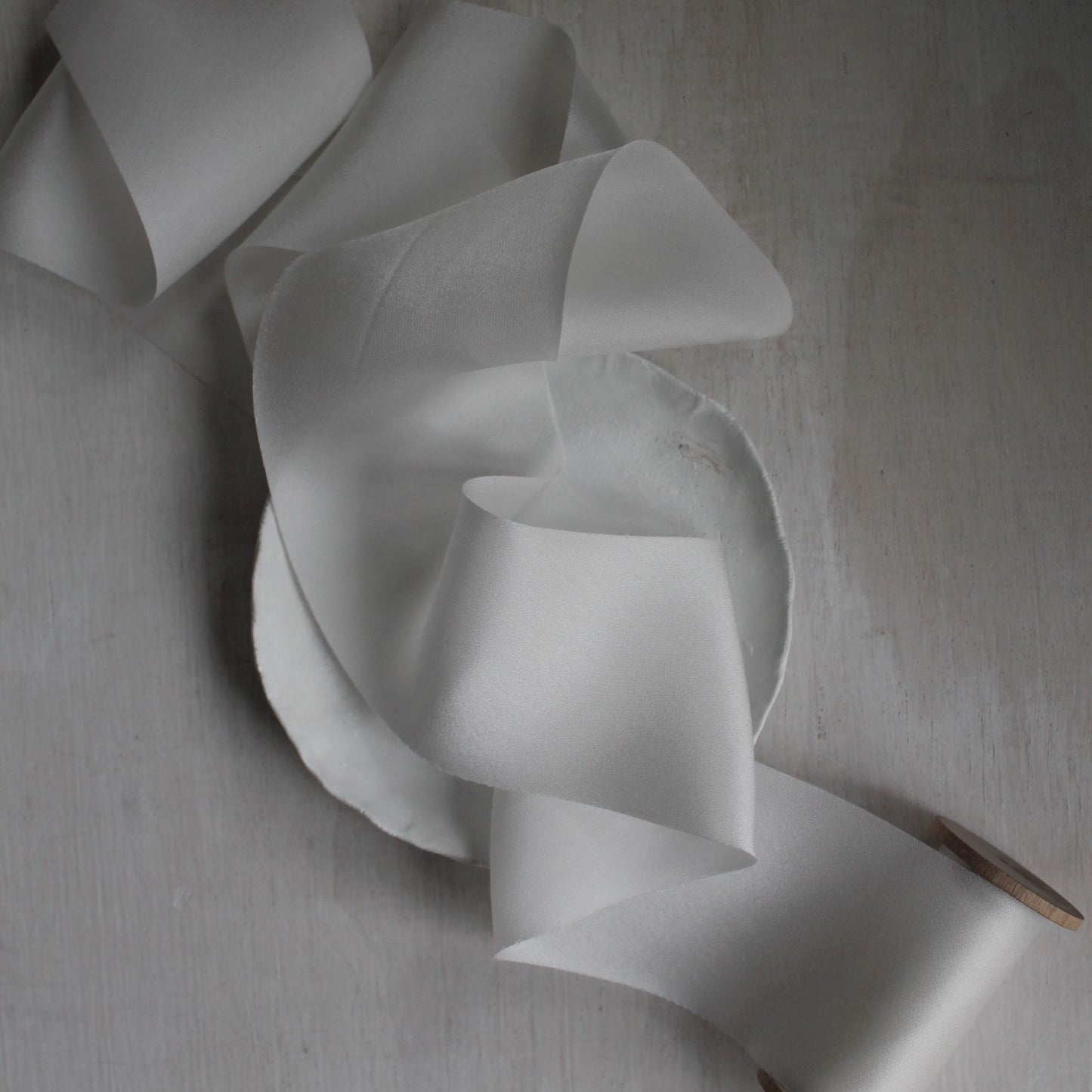 White silk charmeuse ribbon gently draped in folds