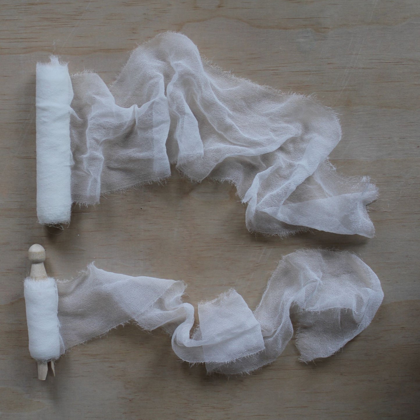White silk chiffon ribbon hand-torn and softly curled, showing its light and airy drape
