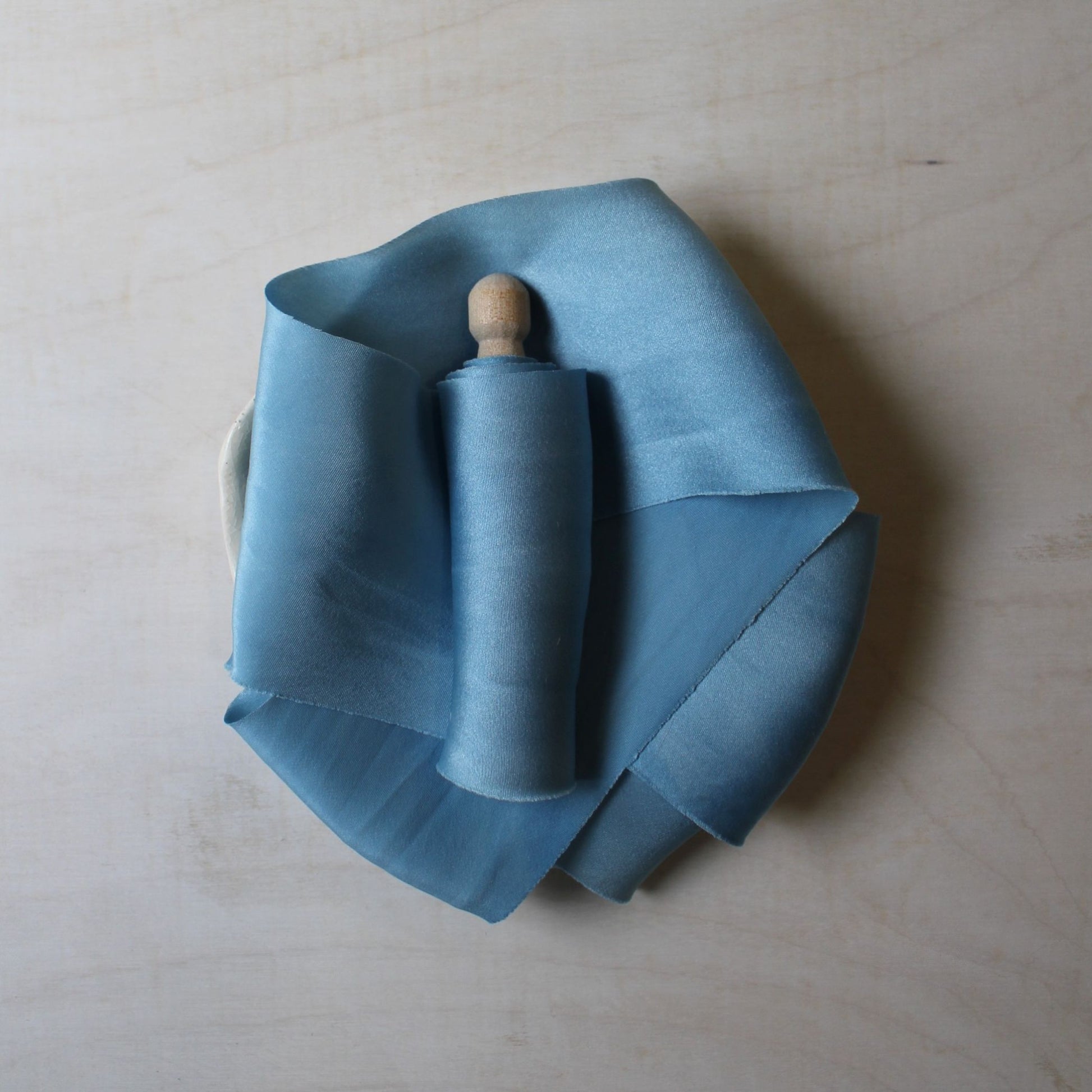 Pale blue charmeuse silk ribbon, naturally dyed with indigo and bias-cut, handmade in Canada for wedding stationery