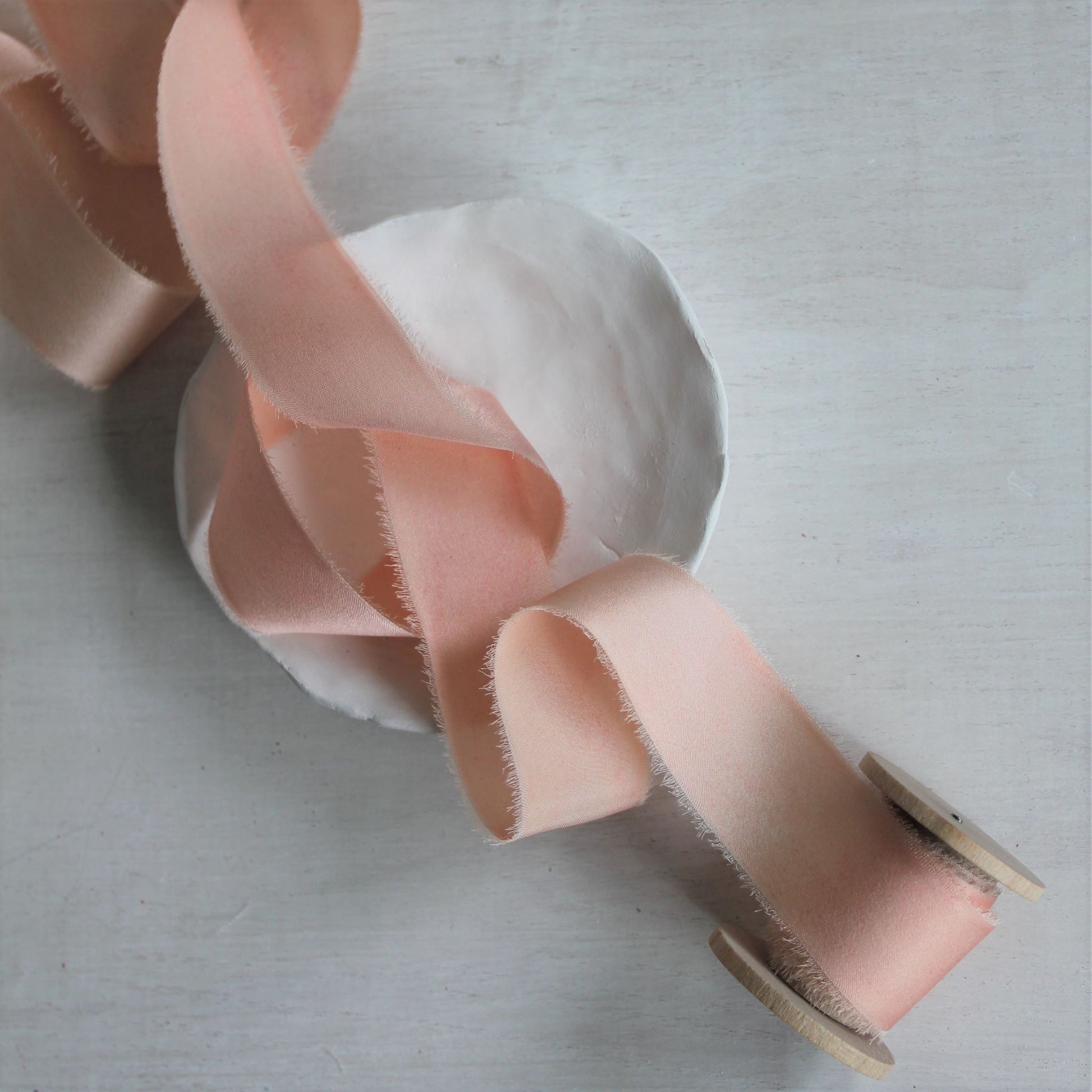 Full view of pink blush silk charmeuse hand-torn ribbon one inch wide