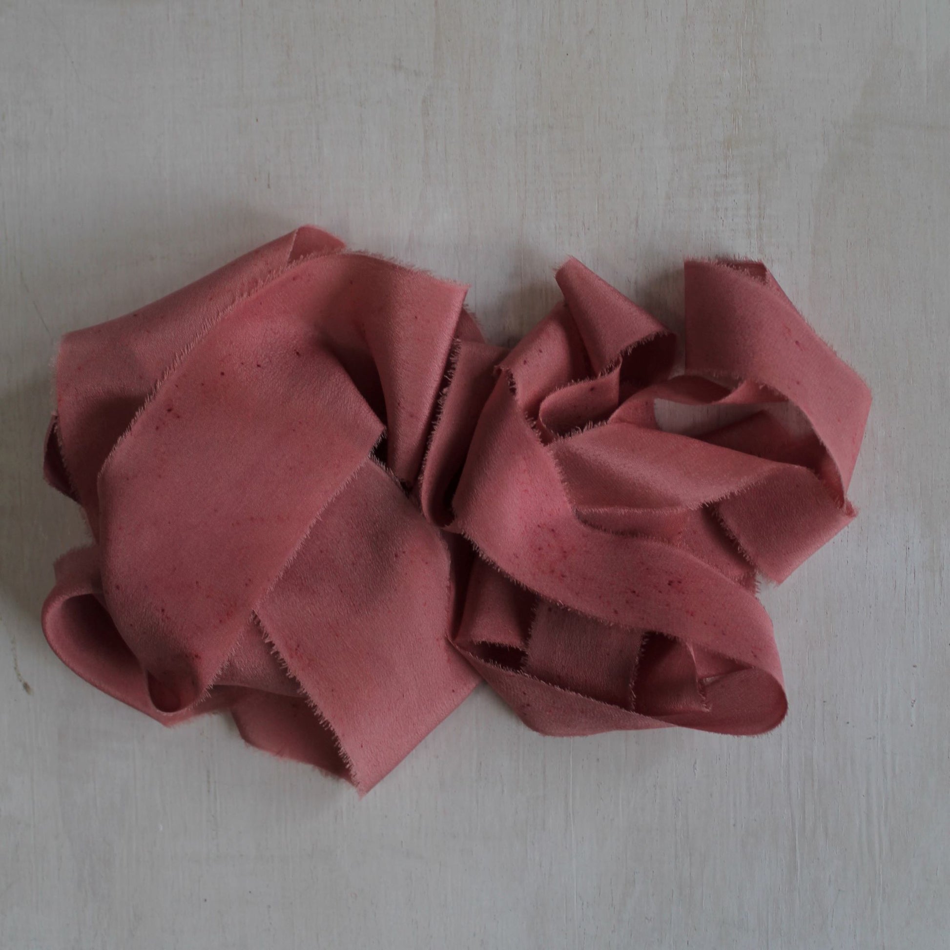 Full view of berry silk crepe de chine hand-torn ribbon.